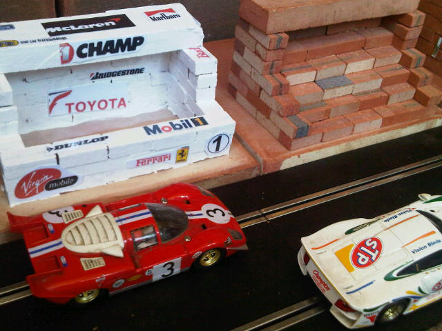 Scalextric Buildings. Pits, Control Building, Restaurant, Grandstand. Similar to original range of plastic Scalextric Goodwood race buildings but in clay - built from mini bricks, painted (or not) and decals added.